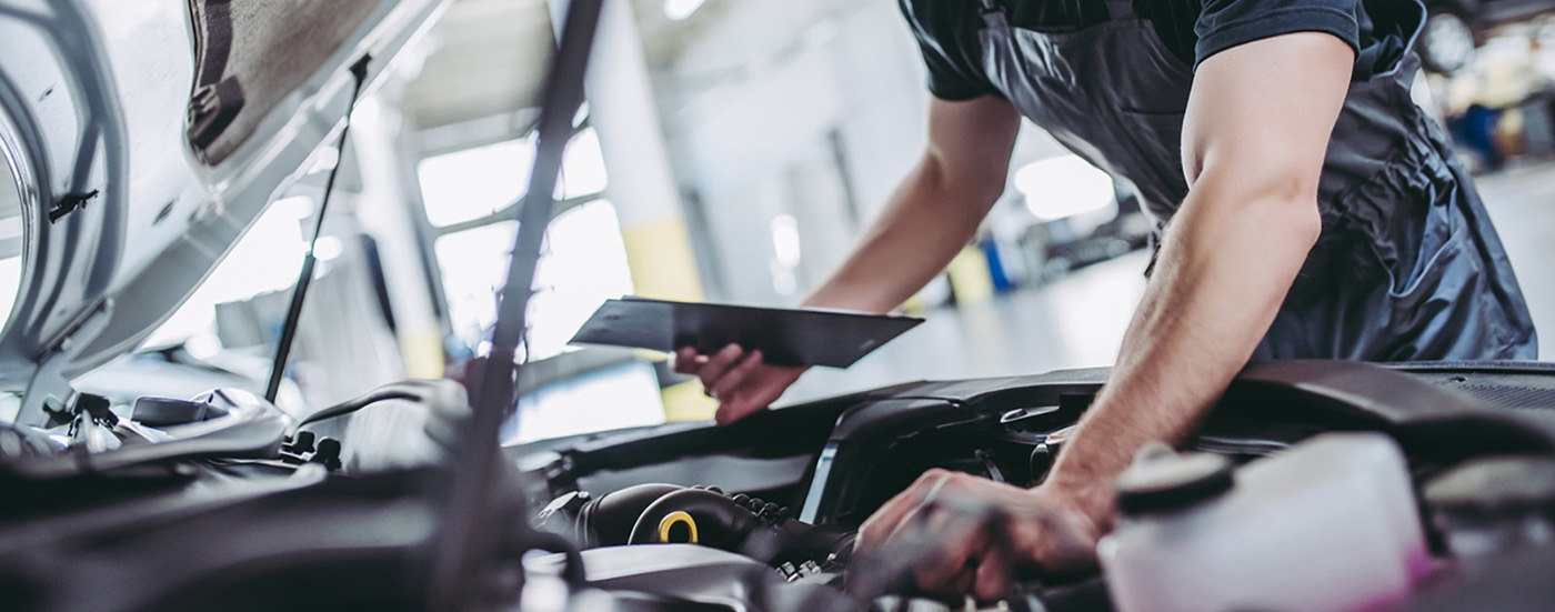 service mechanic checking under hood